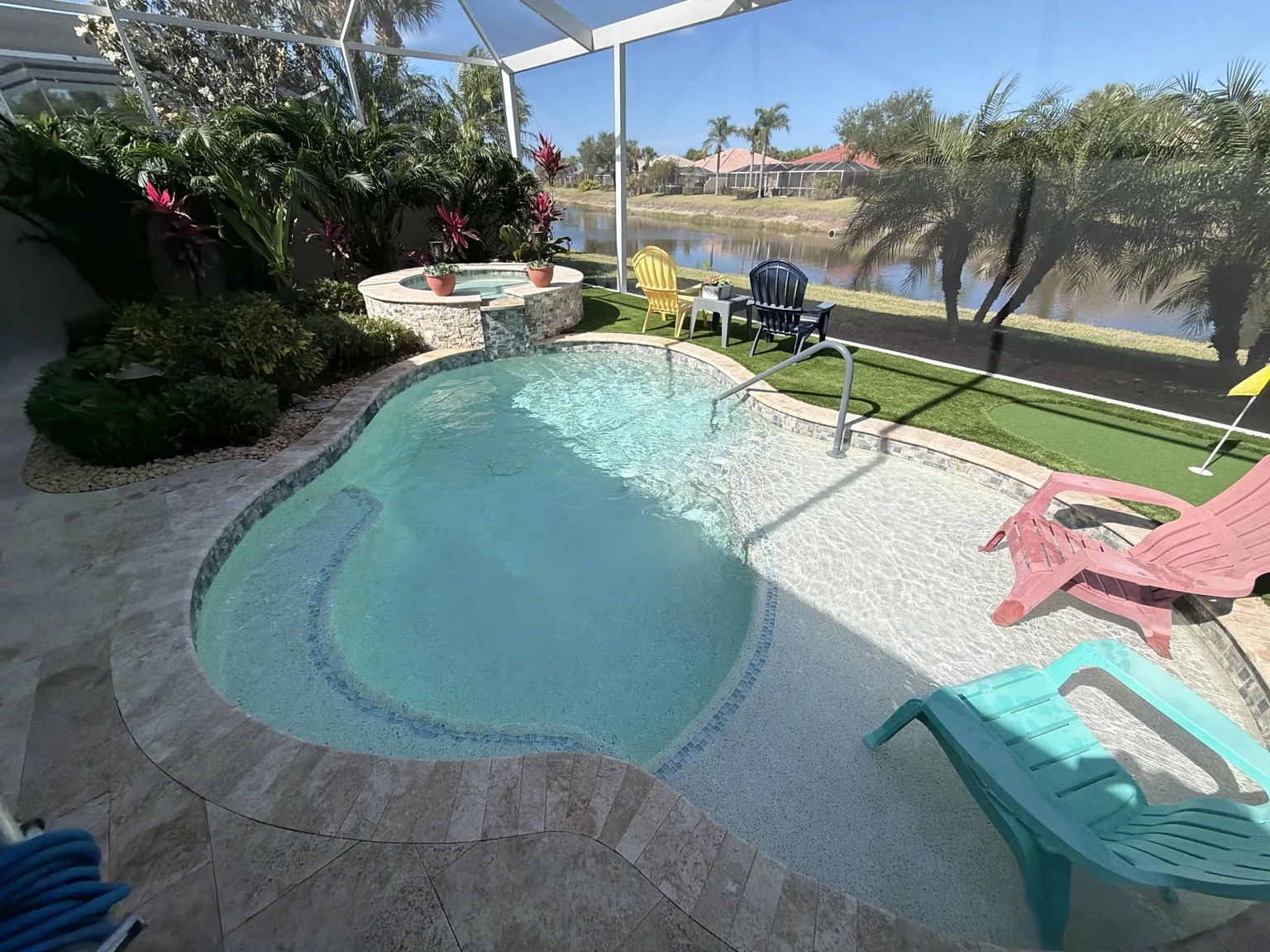 A screened-in backyard pool serviced by K&V Pools